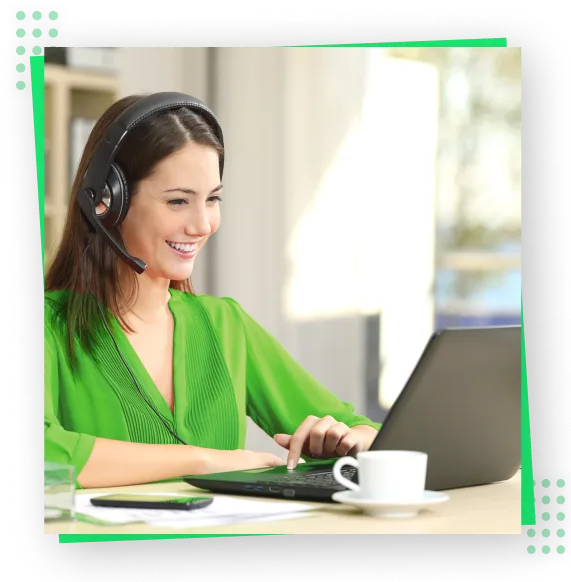 A women wearing headset working on a laptop