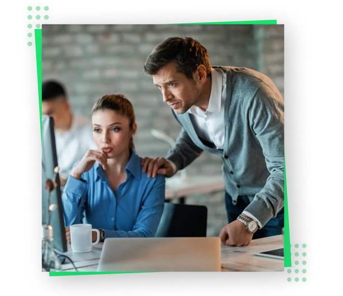 A man and woman exploring website services on a computer screen.