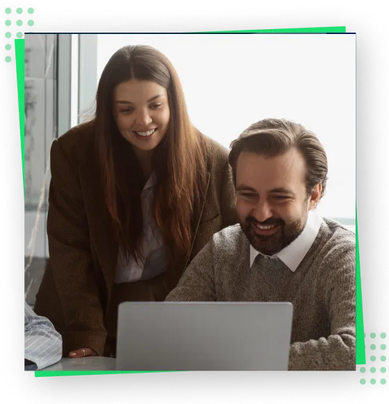a man and woman looking at a laptop