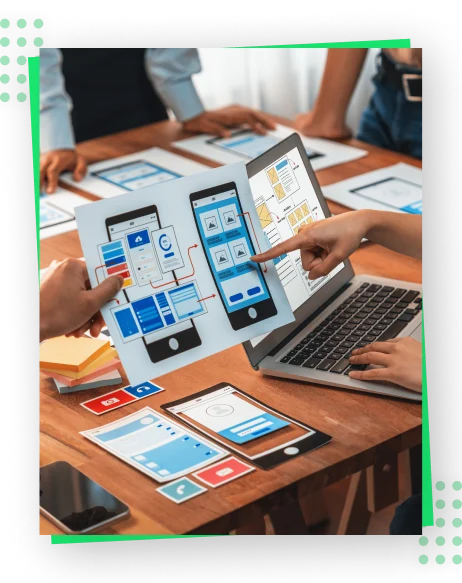 A diverse team collaborates on a laptop, using a mobile app to enhance their productivity.
